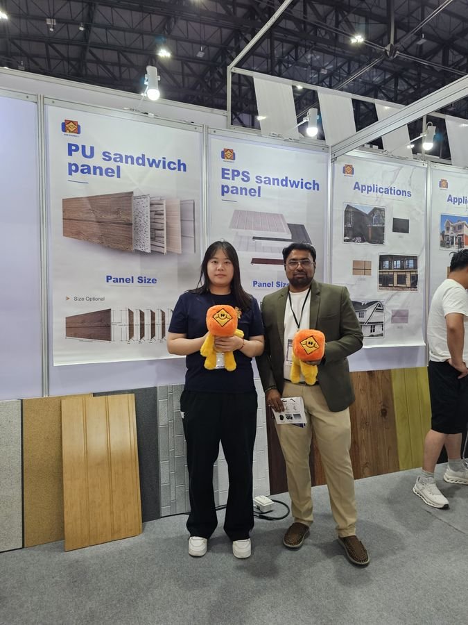 Discussing decorative wall and insulation panel options with an exhibitor.