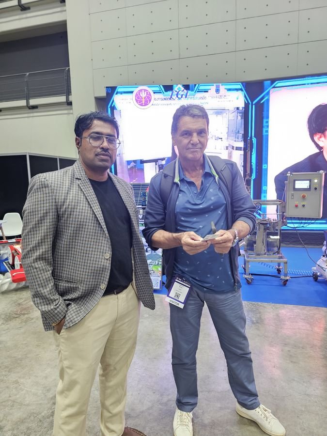 Exchanging business cards with an international visitor at BCT Expo 2026.