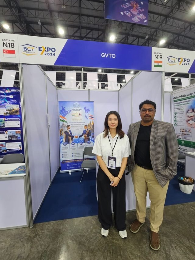 Team members greeting visitors and opening conversations on international collaboration.