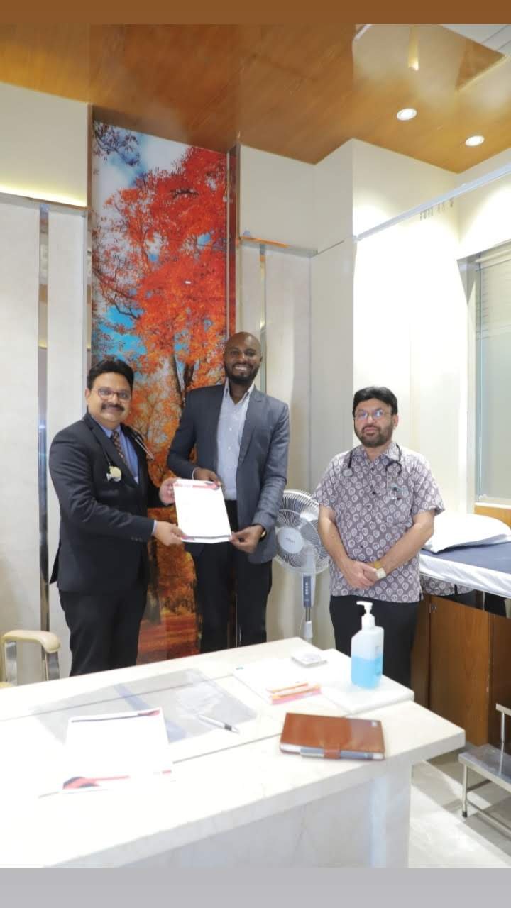 Mr. Malcom from Kenya signing the MoU with Siddhivinayak Hospital, Kolhapur